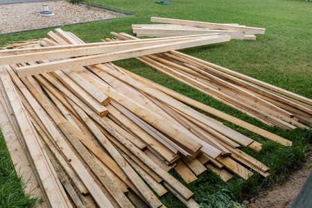 Pile of wooden boards in the sawmill, planking. Wood lumber stack. Construction from ecological...