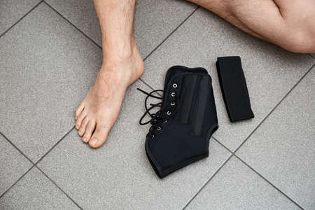 The male leg is fixed in a medical bandage.
