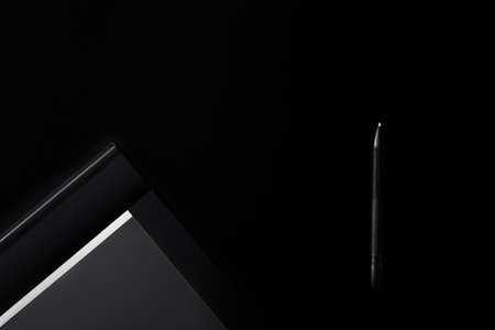 Electronic drawing pen tablet with pen stylus isolated on black background. Copy space. Banner. Empty place for text. Graphic designer tool. Retoucher workplace concept. Equipment for creative artist.の写真素材