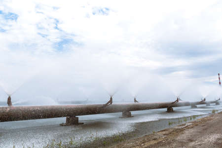 Combined heat and power plant and a lake with cooling fountains. CHP for the production and supply of the city's population with electricity and hot central water supply. Technology and nature.の写真素材