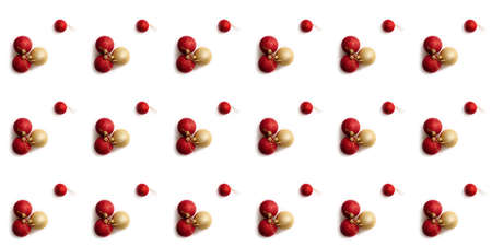 Seamless pattern with red and golden Christmas toy balls on a white background. Christmas texture. Holiday design mockup concept. Poster wallpaper. Festive banner. Template. New year greeting card.の写真素材