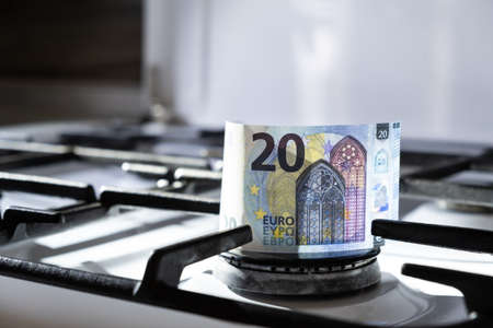 Concept of gas crisis. 20 euro bank note on a stove. Cash money. High prices of natural resources....