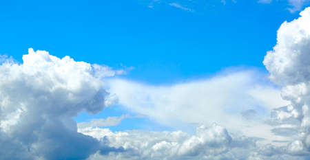 Blue sky with white cumulus clouds. Banner. Background. Nature wallpaper. Sunny weather forecast....