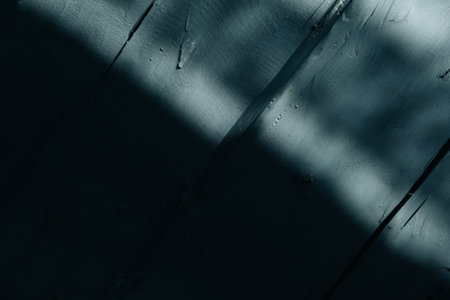 Gray uneven wooden log wall of rough texture with a moonlight from the window. country style. abstract background. Shadow and light. Natural old plank. Gray blue color. moon night. copyspace. Cracks.の写真素材