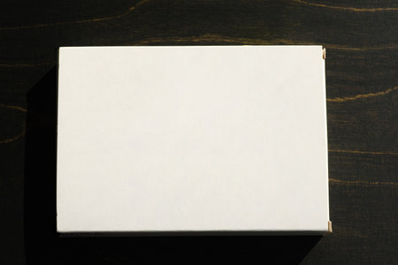 The white cardboard box top view close-up on dark background. Mockup design of medical packaging....