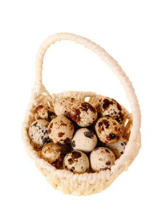White basket full of quail eggs cut out of background. png format. Easter holiday symbol. Religious decoration. Farm eco production. Health food. organic product. closeup. Straw decor.の写真素材
