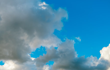 Blue sky with white cumulus clouds moving fast in day light. cloudscape. nature background. Windy weather forecast. religion concept. heaven landscape. fresh air. Morning inspiration. Daylight.の写真素材