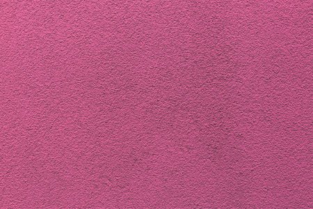 Sample of a texture of pink plaster. Wall finished with a decorative cement stucco. Example of exterior building decoration. Clean uniform grain background. Banner. wallpaper. copyspace. pattern.の写真素材