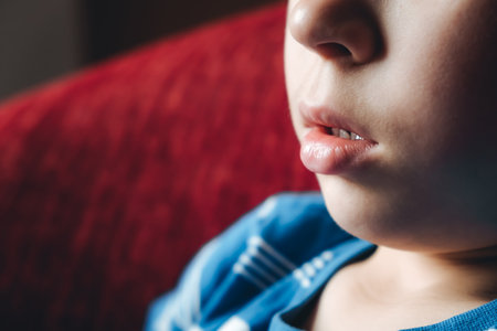 close up face profile. Lips of child. 6 year old boy with open mouth close-up. Weak facial muscles. copyspace. Mouth breathing. The concentrating kid. Nasal congestion. Dry air. runny nose. white skin.の写真素材