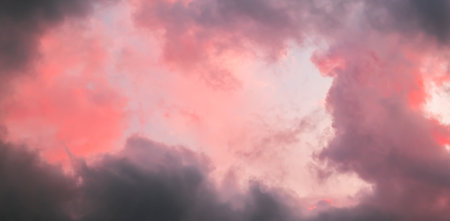Pink sky with stormy clouds. Sunrise clouds are in vanilla colors. Beauty in nature. Details of evening sunset. Natural abstraction. Tension concept. Panoramic view. After thunderstorm.の写真素材