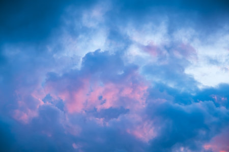 Blue morning sky is in pink clouds. Sunrise clouds are in vanilla colours. Beauty in nature. Twilight time, golden hour. Details of evening sunset. Natural abstraction. Peace concept. Panoramic view.の写真素材