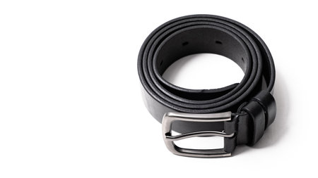 Twisted black leather belt with matted metal buckle isolated on white background. Fastened...