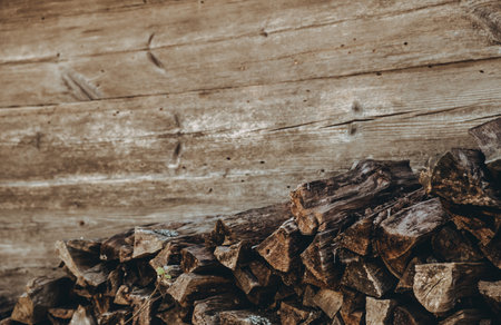 Chopped firewood pile. Woodpile board wall. Wood. Old dry pine wooden heap. Brown color textured background. Natural resources. Rural solid fuel. Winter preparation. Rustic style pattern. Woodworking.の写真素材