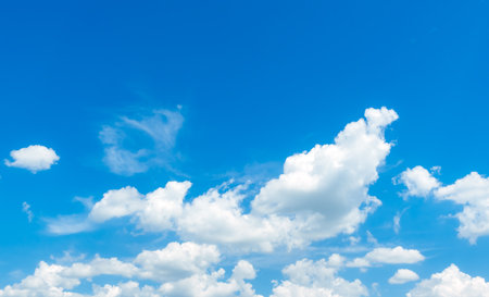 Blue sky with white fluffy clouds. Nature landscape. Cumulus cloud. Sunny summer day. Good weather. Cloudscape background. High quality.の写真素材