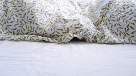 The child is hiding under the blanket. Unmade bed. Rumpled bed. Time to change the bed linen. Floral...
