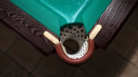 The empty corner pocket of billiards table top view close-up. Playing Russian billiards. Achieve the aim concept. Accurate target. Sport game hobby. Narrow hole. Tactics andの写真素材