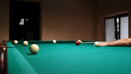 Play Russian or American billiards on a green table. The player hits the red ball with a cue and...