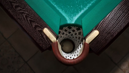 The empty corner pocket of billiards table top view close-up. Playing Russian billiards. Achieve the aim concept. Accurate target. Sport game hobby. Narrow hole. Tactics andの写真素材