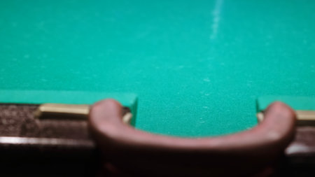The middle pocket of billiard ball close-up. A worn track on the fabric from a variety of games. Playing on a green table. Pastime sport game hobbyの写真素材