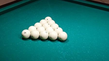 Set of white balls on a green pool table. The first hit. Start of the game. A pyramid is ready close-up. Pastime playing sport hobby. High quality photo.の写真素材