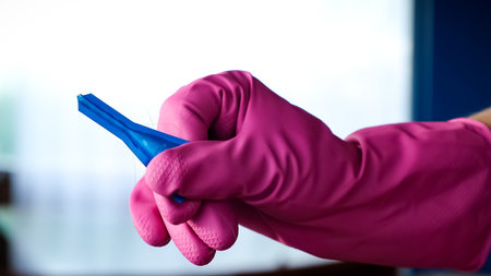 The drops in blue blister in hand in glove on blur background close-up side view. Veterinary and...