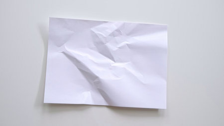 White crumpled paper. Crumpled white paper overlay surface texture for background. Clean white paper, wrinkled, abstract background. Paper background with copy space for text. Highの写真素材