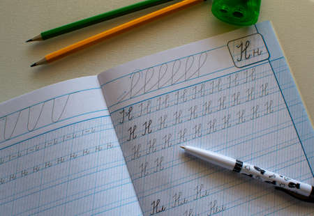 Back to school, learning to write letters correctly, notebook and pencils