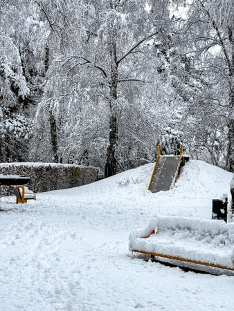 A small playground strewn with white snow