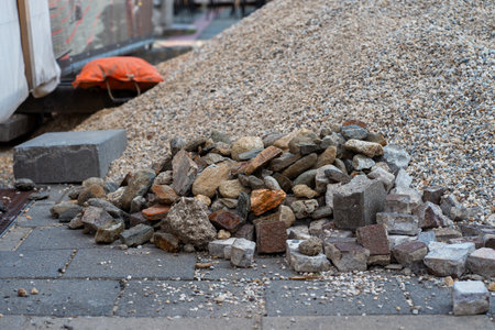 A mountain of rubble and the remains of old paving stones at a construction siteの写真素材