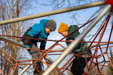 Two boys playing on the playground in the spring