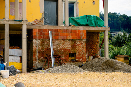 Various building materials and fixtures near a house under construction.の写真素材