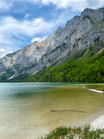 The lake against the background of mountains covered with green forest