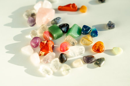 View of various colorful semi-precious polished stones on a white table