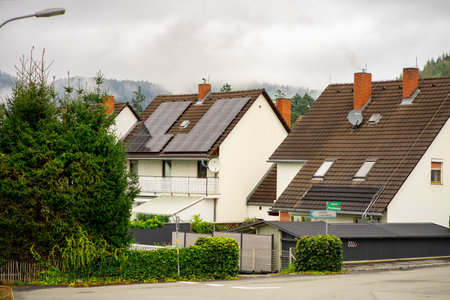View of solar panels installed on the roof of a residential buildingの写真素材