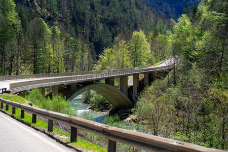 View of a small stone bridge over a mountain river in the Austrian Alps