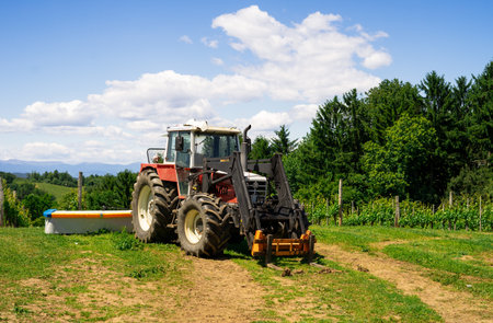 View of a tractor prepared for work in a farmers field. Farm equipment. Equipment for working on...