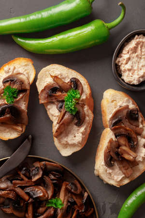 Toast with soft cheese and mushrooms. Peppers. Green pepper on toast. Mushrooms on bread Cheese. Green and black. Brownの写真素材