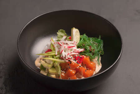 Restaurant menu. Salad with red fish, radish, seaweed, avocado, radish, caviar and greens. Lime...