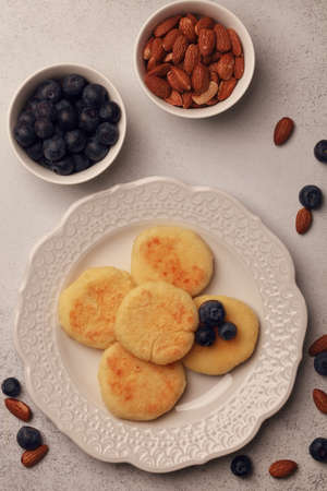 Breakfast of pancakes and yoghurt. Fresh berries and nuts. Blueberries with almonds. Cheesecakes...