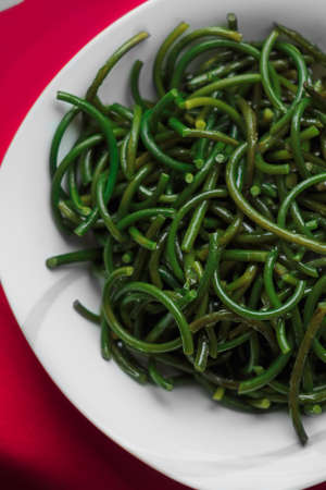 Fresh garlic arrows. The green garlic. Garlic with salt. Healthy snacks