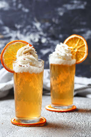 Cocktail with cream and orange. Dried orange with orange juice