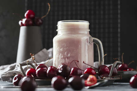 A glass of milkshake with cherries. Concept of a healthy lifestyleの写真素材