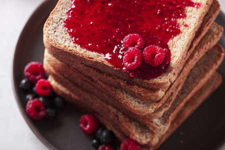 Toast with jam. Raspberry and apricot jam with berries. Fruit jam for Breakfast. Fresh and healthy...
