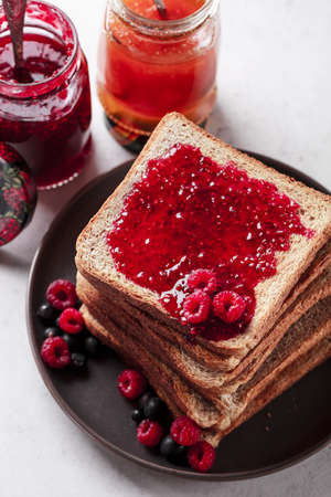 Toast with jam. Raspberry and apricot jam with berries. Fruit jam for Breakfast. Fresh and healthy...