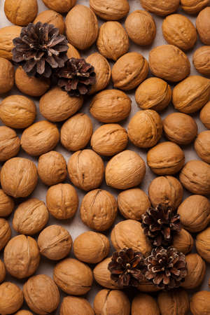 Healthy lifestyle. Healthy and fresh snack with nuts. Walnuts and winter cones. Nuts as a background