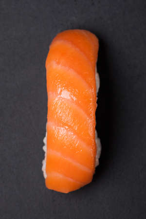 Sushi and rolls. Rolls for the Asian menu.On a black background. Raw fish and rice. Shrimp, salmon, squid, caviarの写真素材