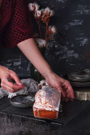 Freshly baked poppy seed pie. Cake with fondant. Baking with poppy seeds on a dark backgroundの写真素材