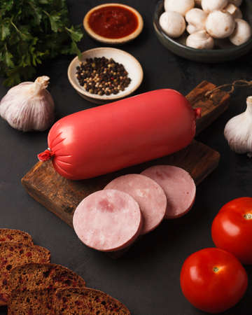 Meat and sausage delicacies. Cold cut. Sausage, bacon, carpaccio, knuckle. Sausage slicingの写真素材