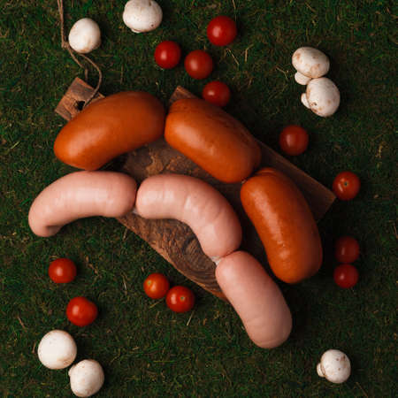 Meat and sausage delicacies. Cold cut. Sausage, bacon, carpaccio, knuckle. Sausage slicingの写真素材