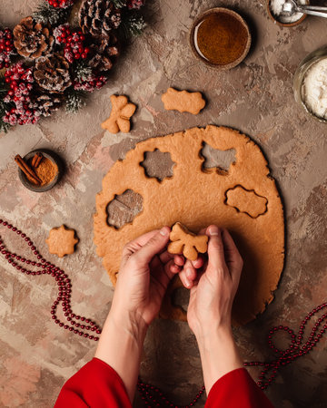 Cooking new year's ginger cookies. Christmas tree on the table with candles.の写真素材